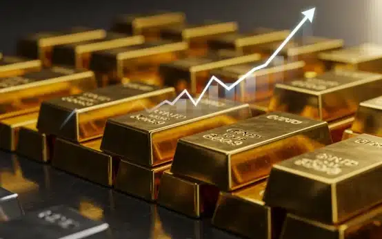 Gold and silver bars with a rising market graph in the background, symbolizing precious metals investment growth.